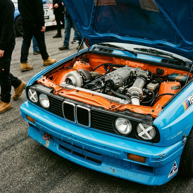 Blue BMW E30 race car with exposed orange engine — Race Prep